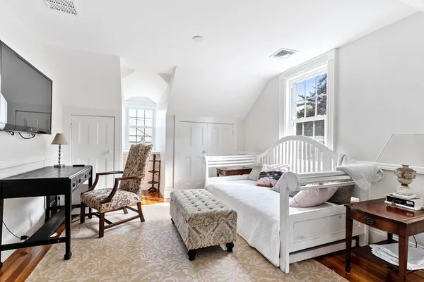 a bedroom with furniture and a window