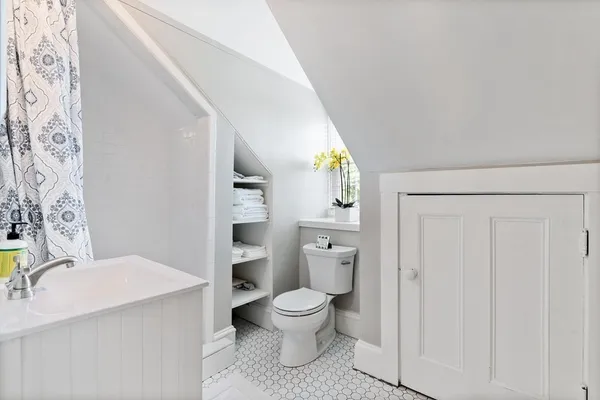 a bathroom with a granite countertop toilet a sink and a mirror