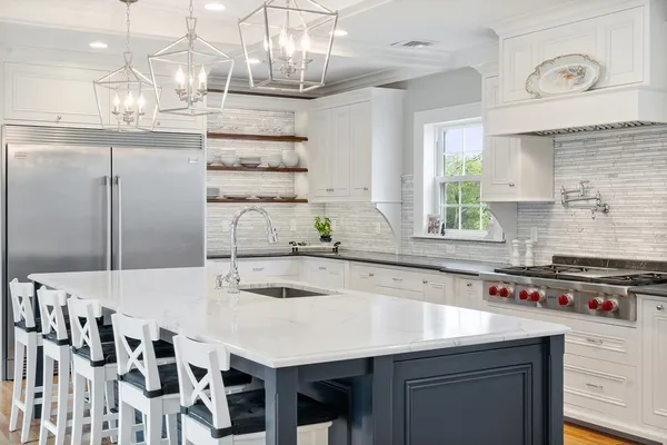 a kitchen with stainless steel appliances a sink and cabinets