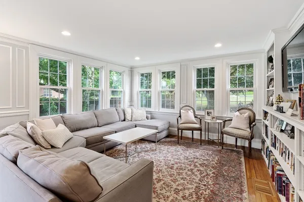 a living room with furniture and large windows