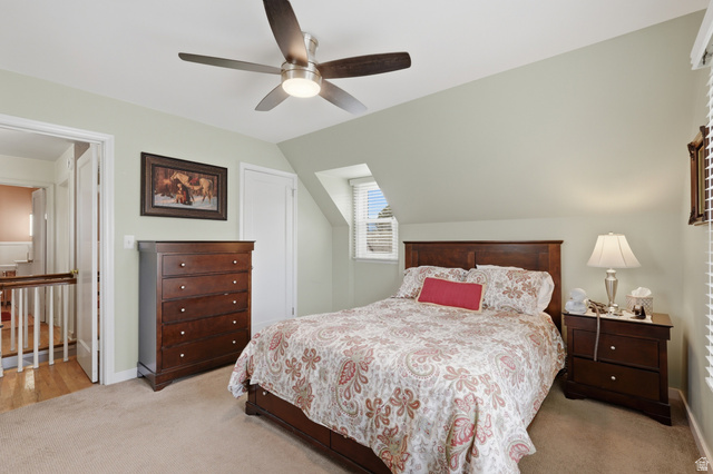 7576 South Jefferson Street Midvale, UT 84047 - Photo 27 of 53 Carpeted bedroom featuring a sloped ceiling and a ceiling fan with integrated lighting