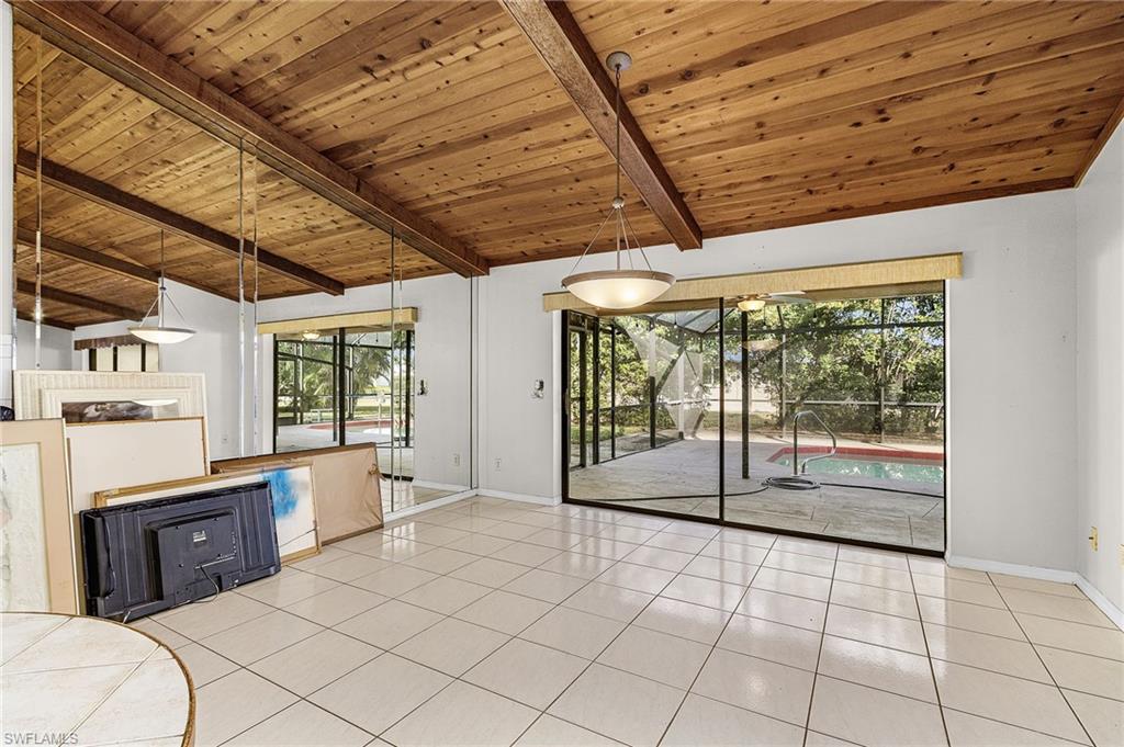 403 Southwest 34th Street Cape Coral, FL 33914 - Photo 20 of 32 Unfurnished living room featuring wooden ceiling, healthy amount of natural light, and light tile patterned flooring