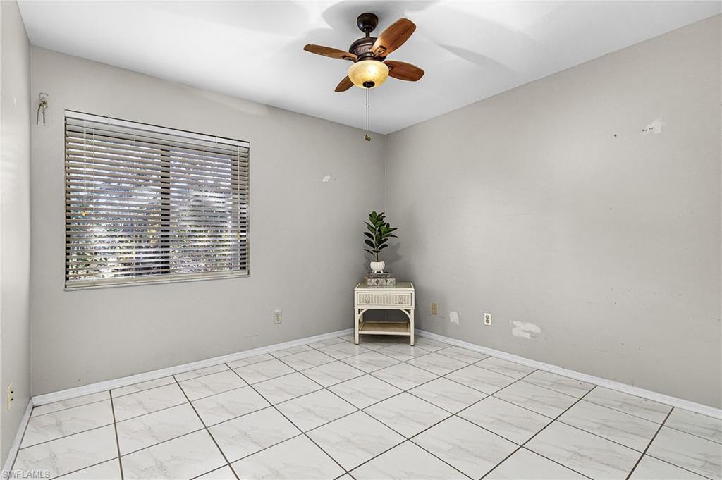 403 Southwest 34th Street Cape Coral, FL 33914 - Photo 22 of 32 Unfurnished room with a ceiling fan and baseboards