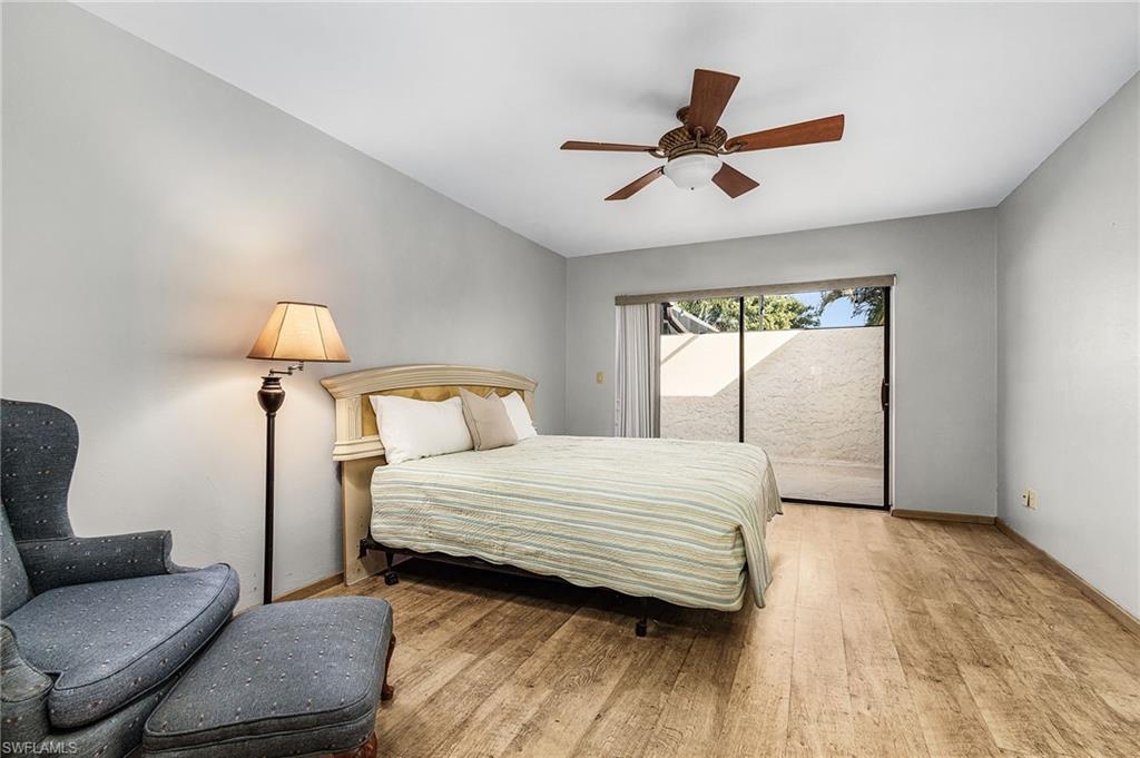 403 Southwest 34th Street Cape Coral, FL 33914 - Photo 25 of 32 Bedroom featuring access to exterior, light wood finished floors, and a ceiling fan