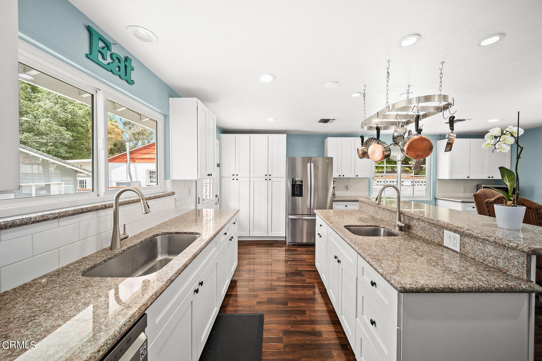 9765 Tujunga Canyon Boulevard Tujunga, CA 91042 - Photo 17 of 51 a large white kitchen with a large window and stainless steel appliances