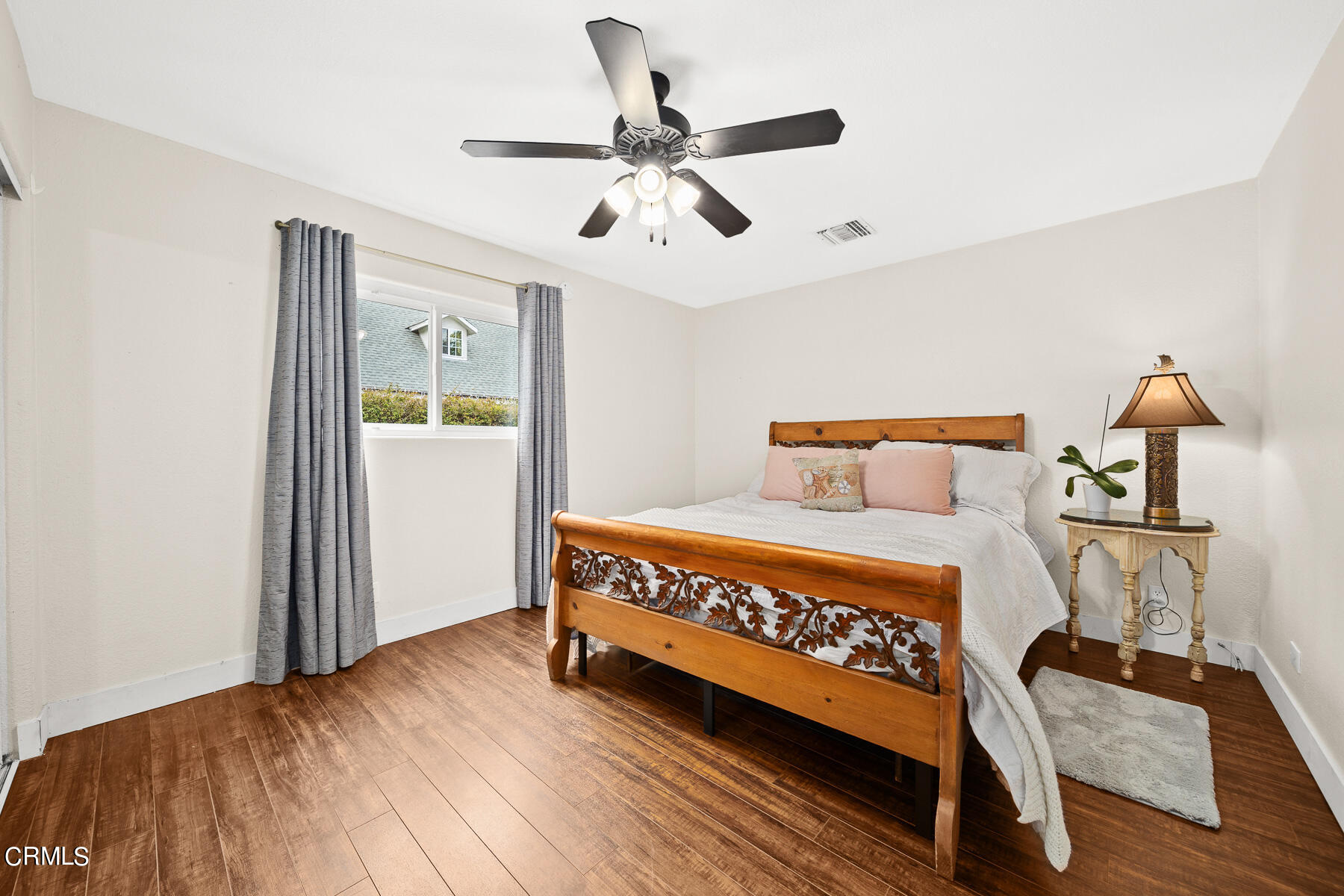 9765 Tujunga Canyon Boulevard Tujunga, CA 91042 - Photo 18 of 51 a bedroom with a bed and wooden floor
