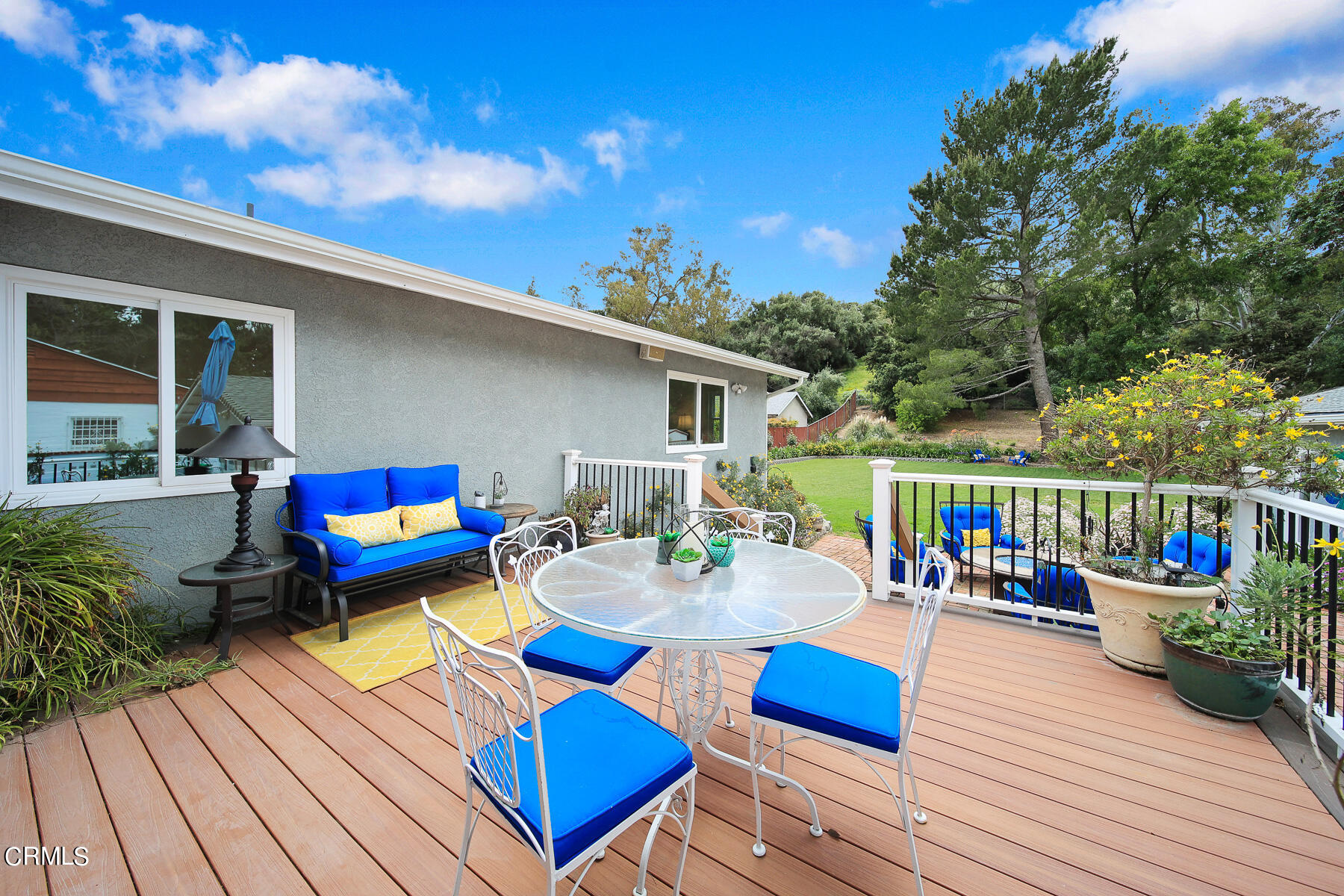 9765 Tujunga Canyon Boulevard Tujunga, CA 91042 - Photo 24 of 51 a view of deck with patio table and chairs couches with wooden floor and fence