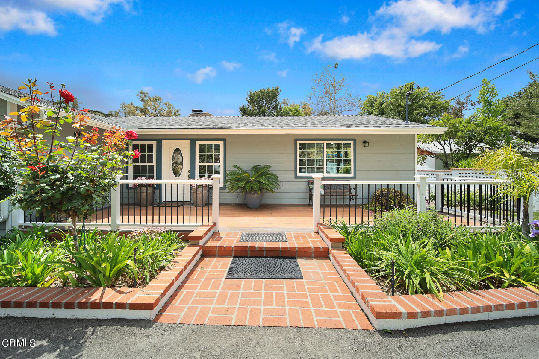 9765 Tujunga Canyon Boulevard Tujunga, CA 91042 - Photo 6 of 51 a view of a house with a small yard and potted plants