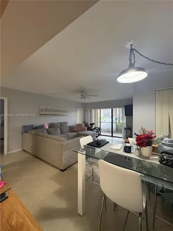 a living room with furniture a chandelier and a dining table