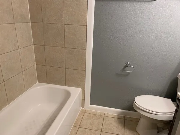 a bathroom with a bathtub and toilet