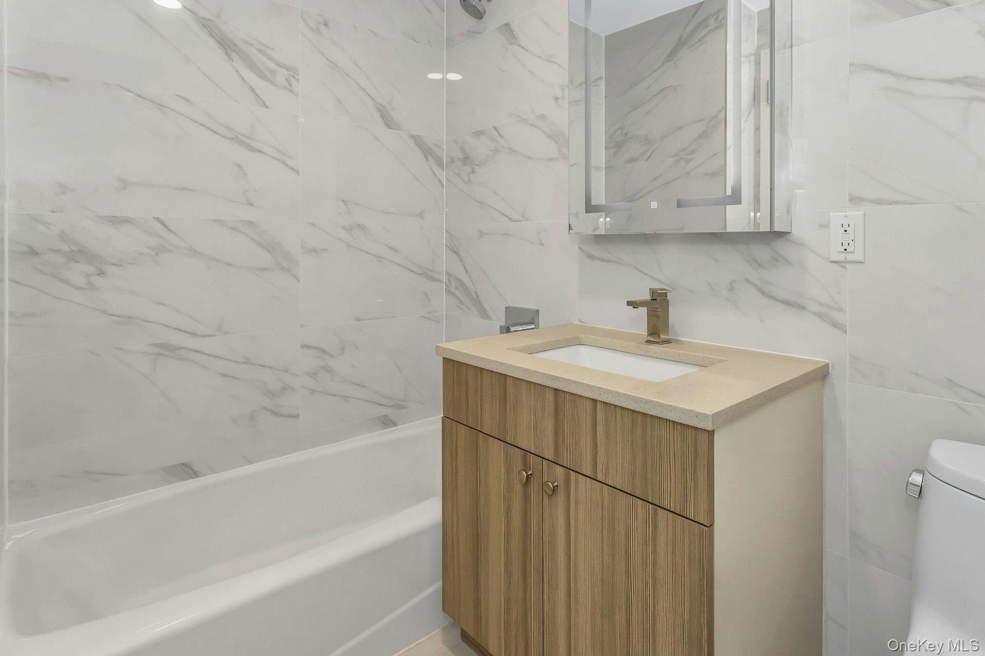 88-08 Justice Avenue, Unit 15N Queens, NY 11373 - Photo 11 of 20 a bathroom with a sink and a bathtub