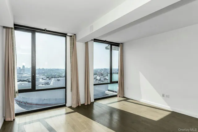 a view of an empty room and window with an empty room