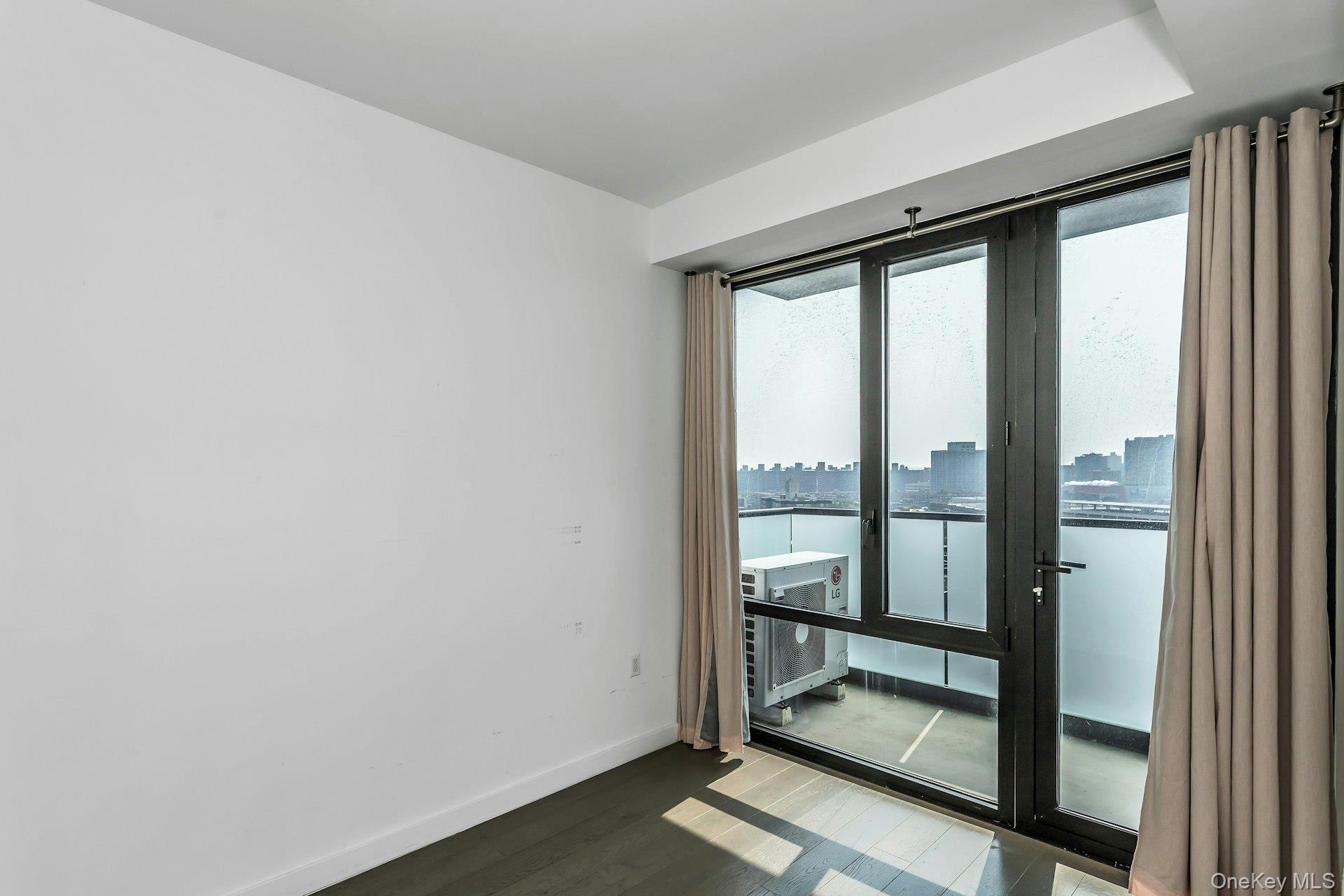 88-08 Justice Avenue, Unit 15N Queens, NY 11373 - Photo 8 of 20 a view of an empty room and window