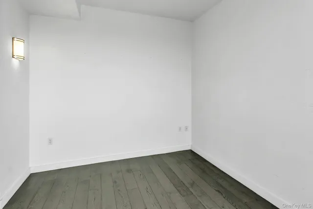 a view of an empty room and wooden floor