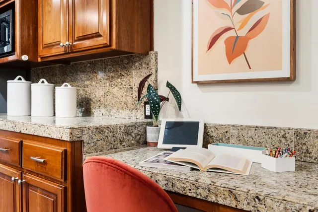a kitchen with stainless steel appliances granite countertop a sink and a microwave