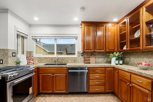 a kitchen with stainless steel appliances granite countertop a stove and a sink