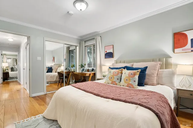 a bedroom with double bed and a view of living room