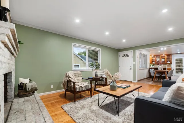 a living room with furniture a rug and a table