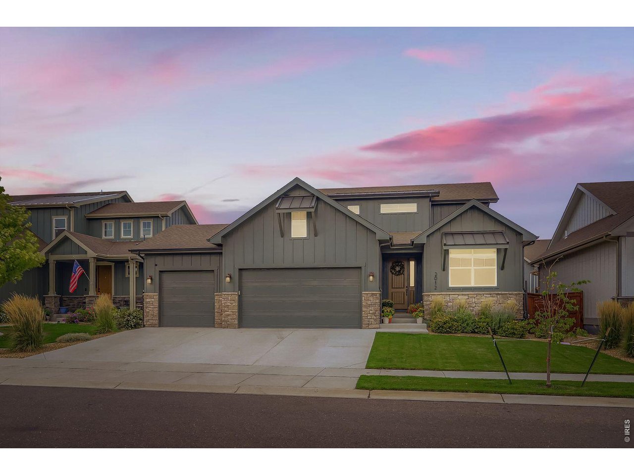 2012 Day Spring Drive Windsor, CO 80550 - Photo 2 of 31 Charming curb appeal with a three-car garage and welcoming front entry at sunset.