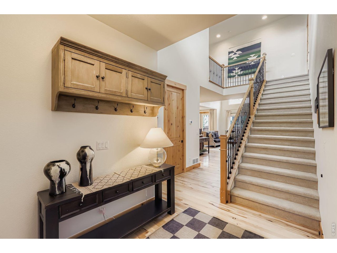 2012 Day Spring Drive Windsor, CO 80550 - Photo 4 of 31 Welcoming entryway with warm wood accents and a view into the sunlit living room beyond.