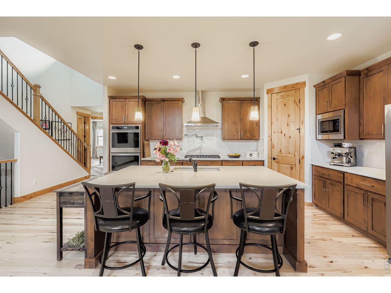 2012 Day Spring Drive Windsor, CO 80550 - Photo 8 of 31 Tharp wood cabinetry meets modern touches in this spacious, entertainer-ready kitchen.