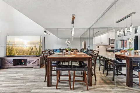 a dinning area with furniture and wooden floor