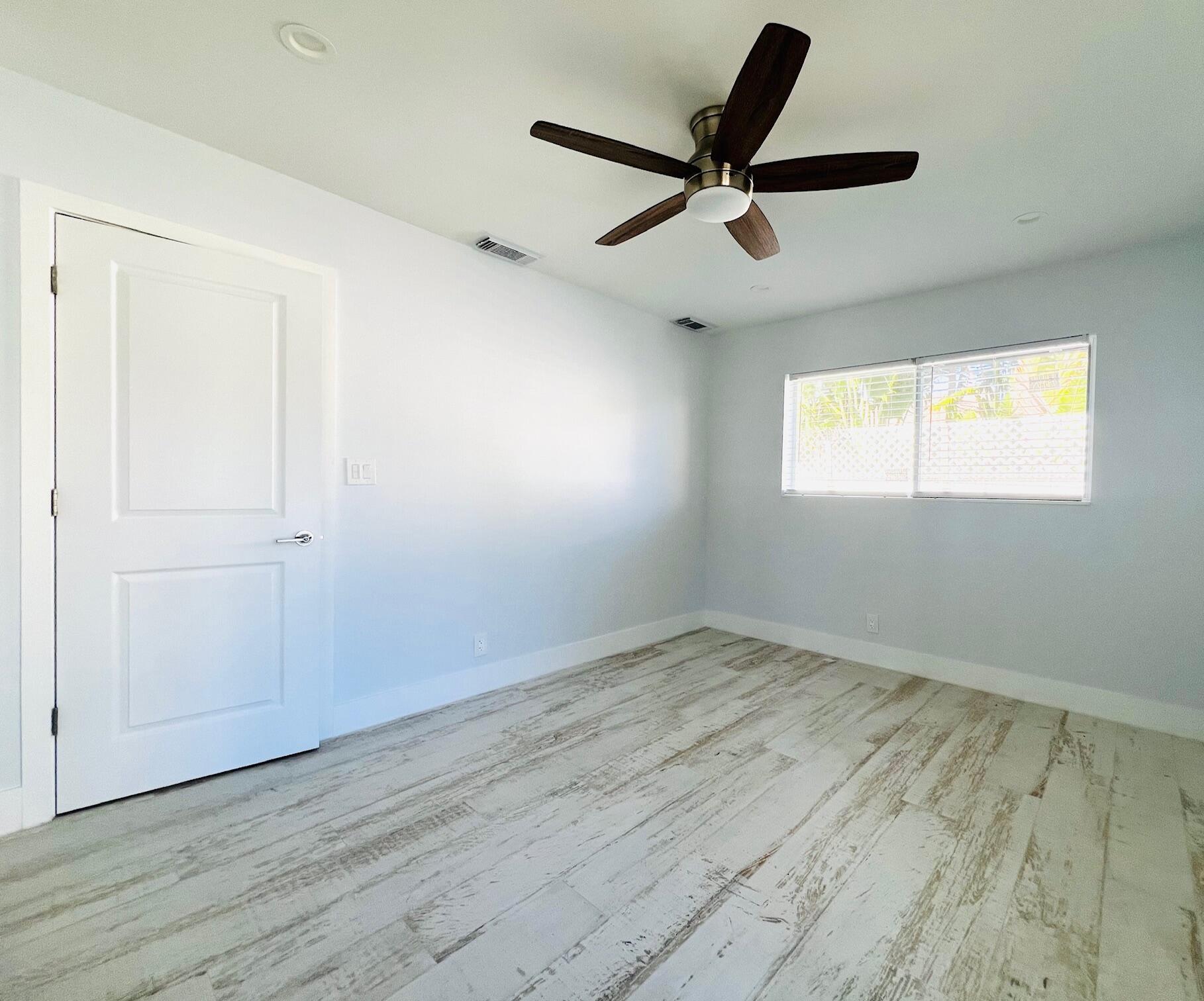 206 Southeast 1st Avenue, Unit 5 Delray Beach, FL 33444 - Photo 7 of 8 wooden floor in an empty room with a window