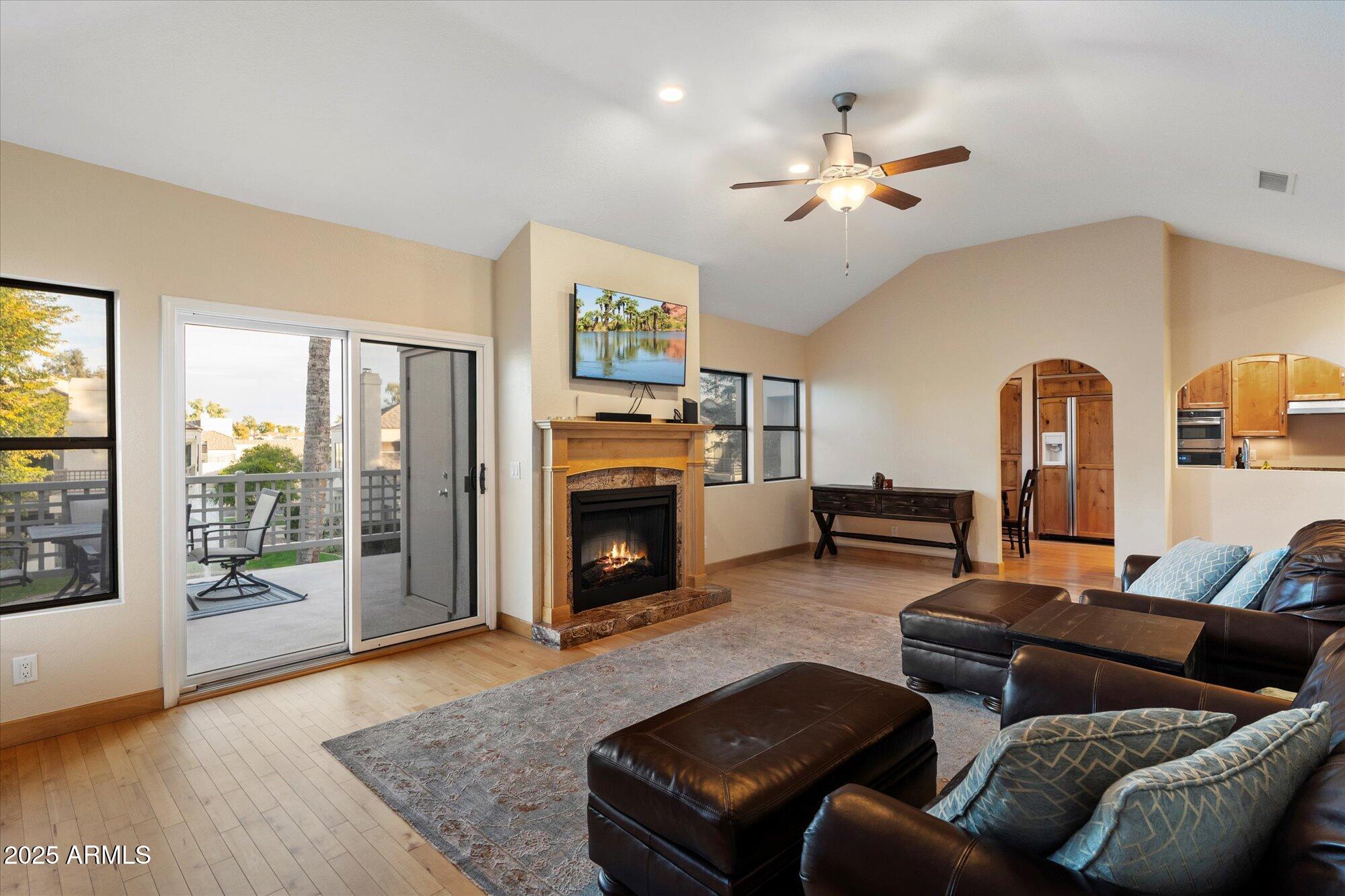 7272 East Gainey Ranch Road, Unit 104 Scottsdale, AZ 85258 - Photo 11 of 45 a living room with furniture and a fireplace
