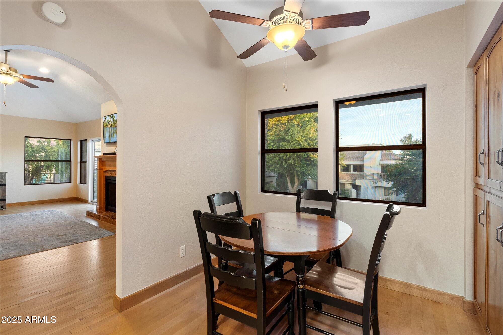 7272 East Gainey Ranch Road, Unit 104 Scottsdale, AZ 85258 - Photo 19 of 45 a dining room with furniture window and wooden floor