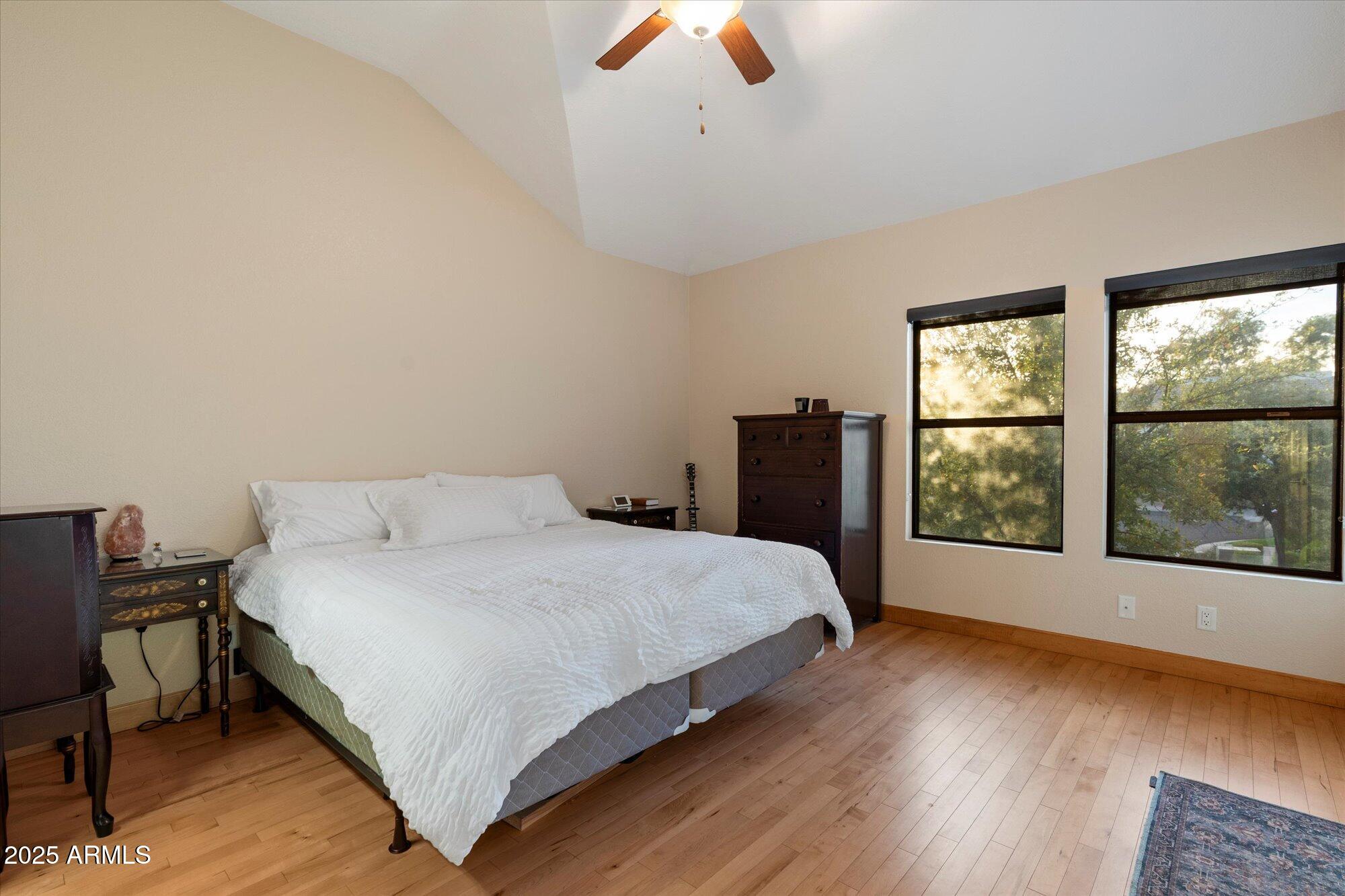 7272 East Gainey Ranch Road, Unit 104 Scottsdale, AZ 85258 - Photo 20 of 45 a large bed sitting in a bedroom next to a window