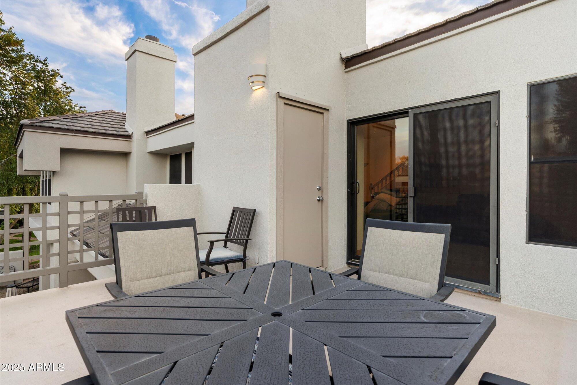 7272 East Gainey Ranch Road, Unit 104 Scottsdale, AZ 85258 - Photo 28 of 45 a view of a dining room with furniture and wooden floor