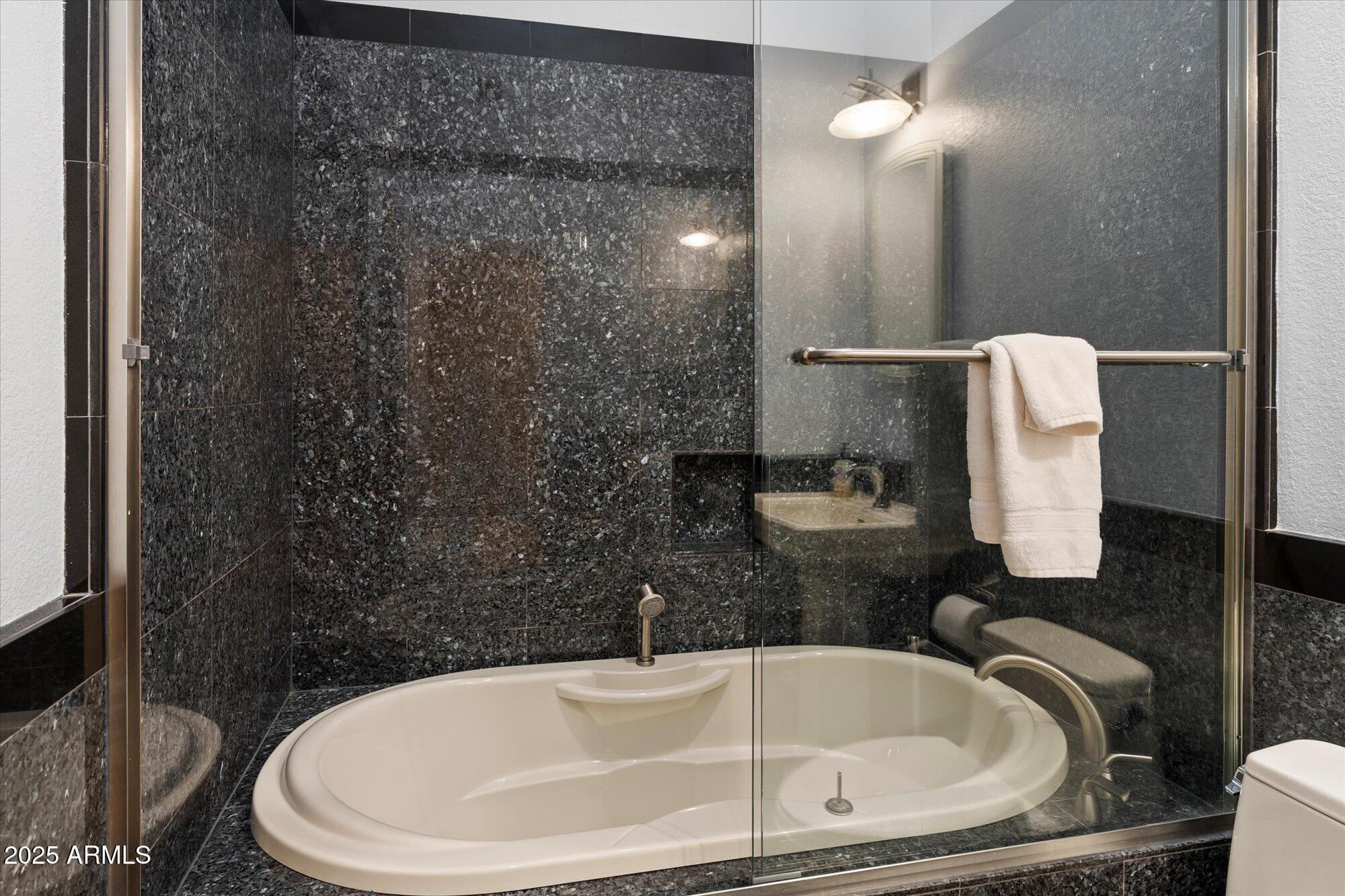 7272 East Gainey Ranch Road, Unit 104 Scottsdale, AZ 85258 - Photo 31 of 45 a bathroom with a sink a toilet and shower