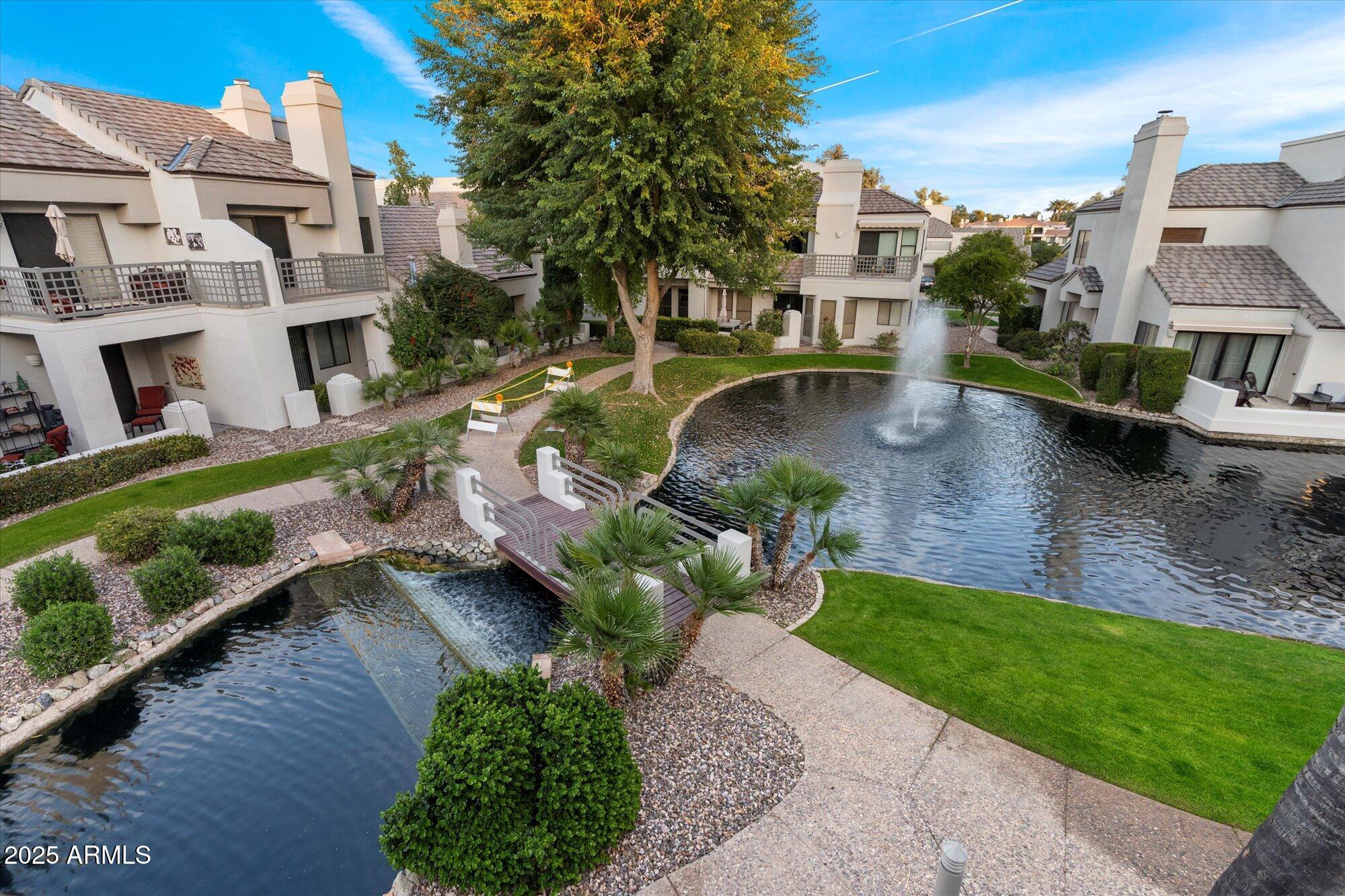 7272 East Gainey Ranch Road, Unit 104 Scottsdale, AZ 85258 - Photo 36 of 45 a view of a house with a yard