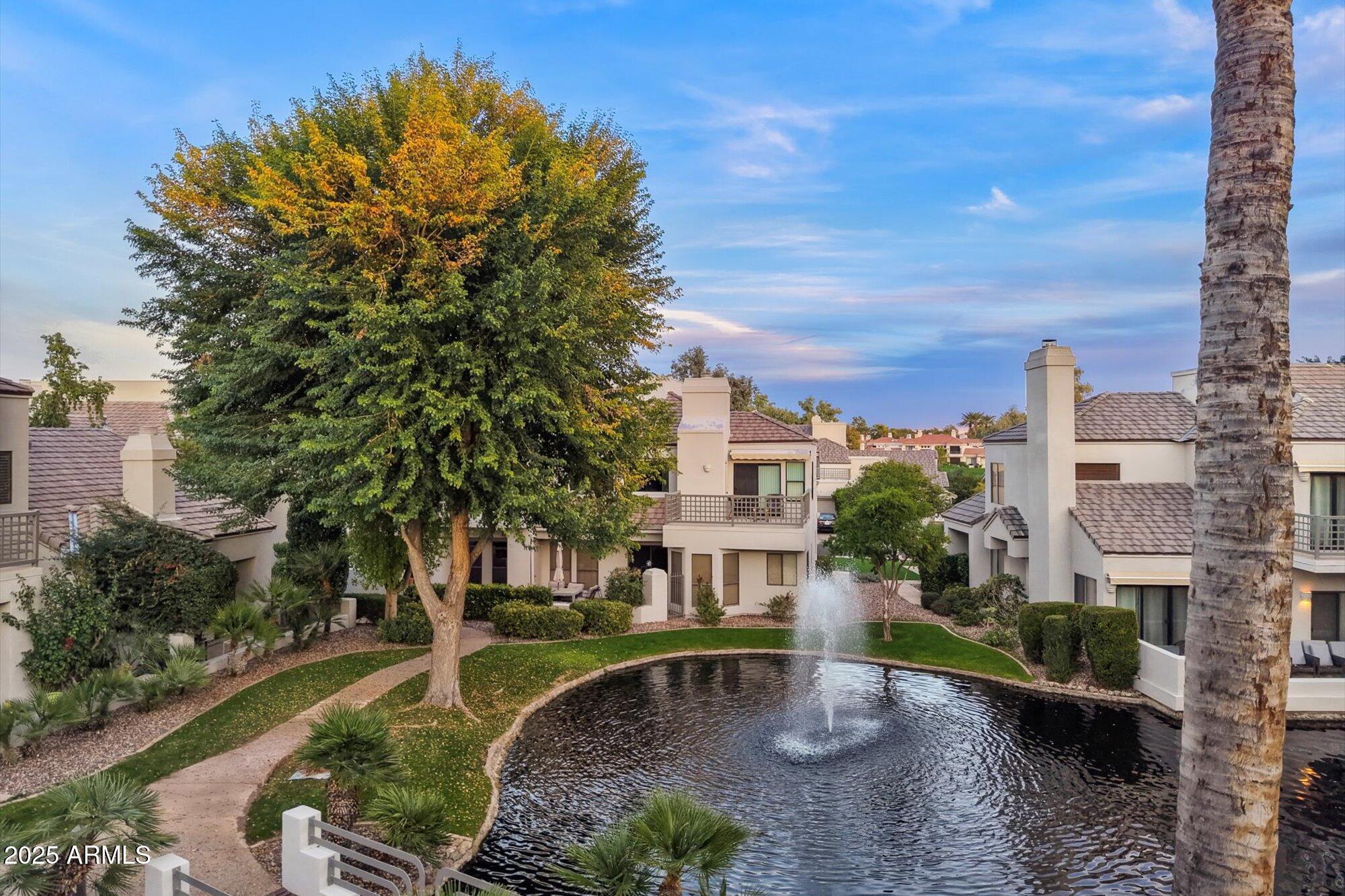 7272 East Gainey Ranch Road, Unit 104 Scottsdale, AZ 85258 - Photo 37 of 45 a view of a house with a yard