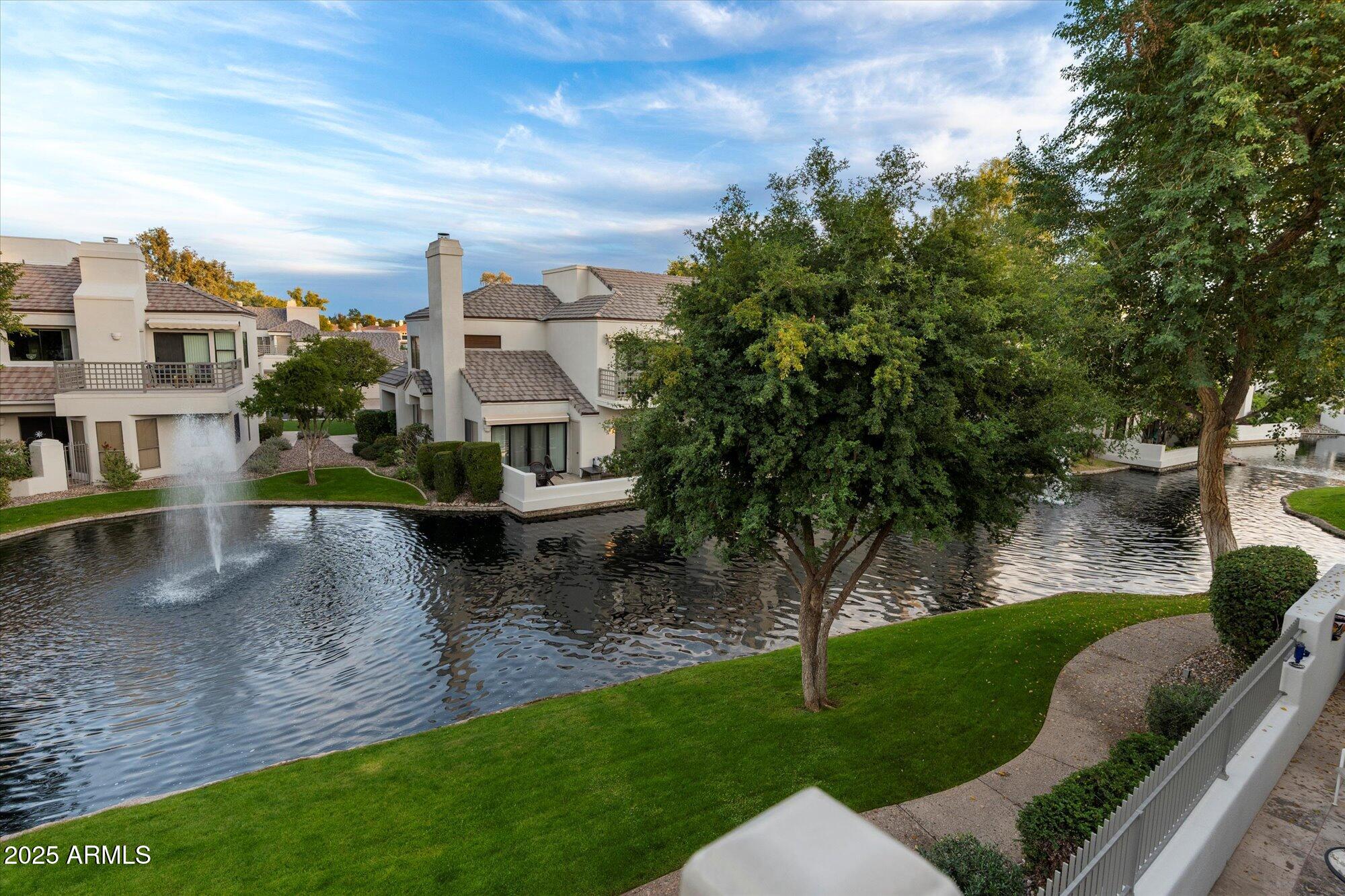 7272 East Gainey Ranch Road, Unit 104 Scottsdale, AZ 85258 - Photo 39 of 45 a view of a house with a yard and sitting area