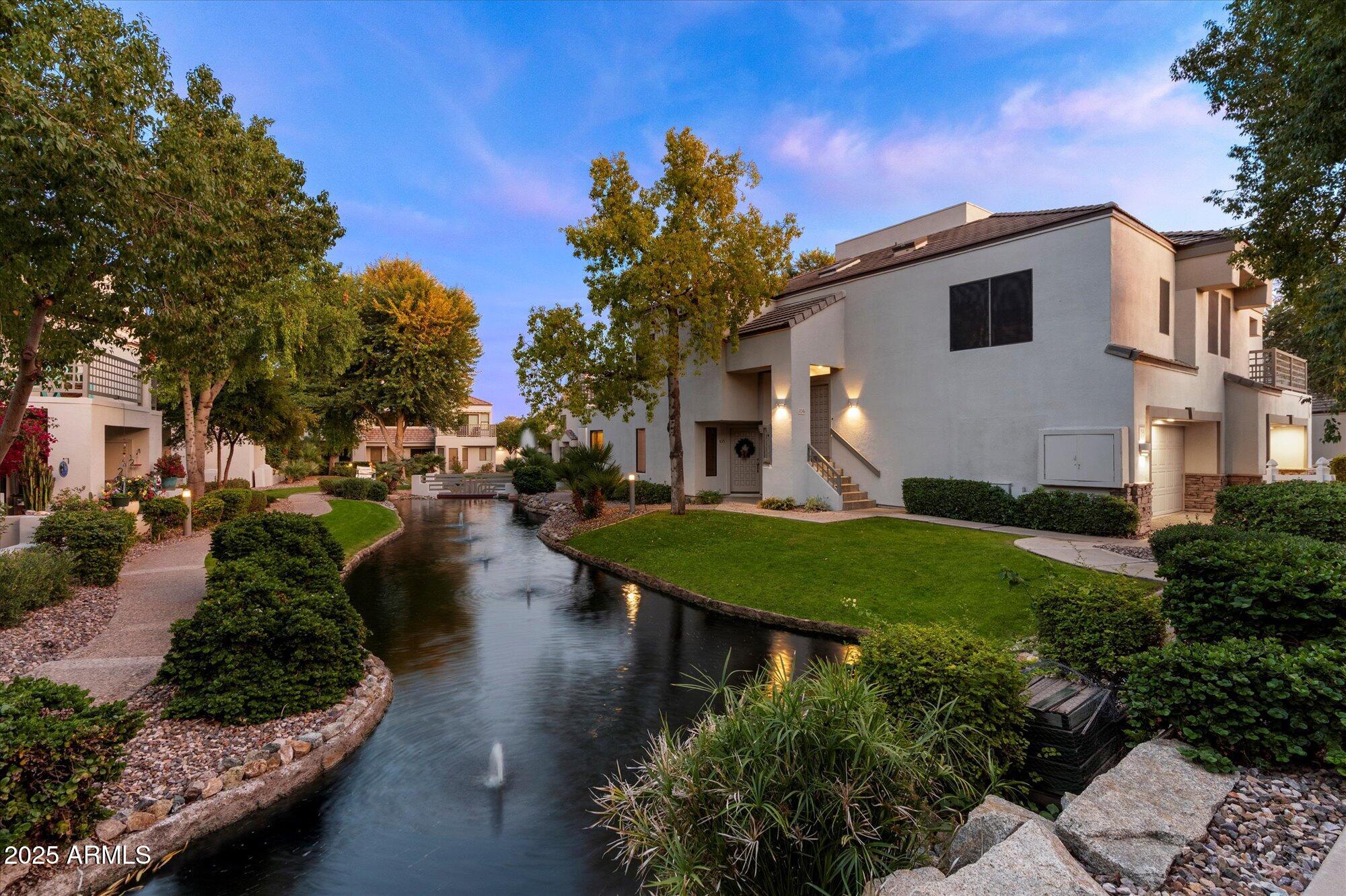 7272 East Gainey Ranch Road, Unit 104 Scottsdale, AZ 85258 - Photo 5 of 45 a view of a house with a yard and sitting area
