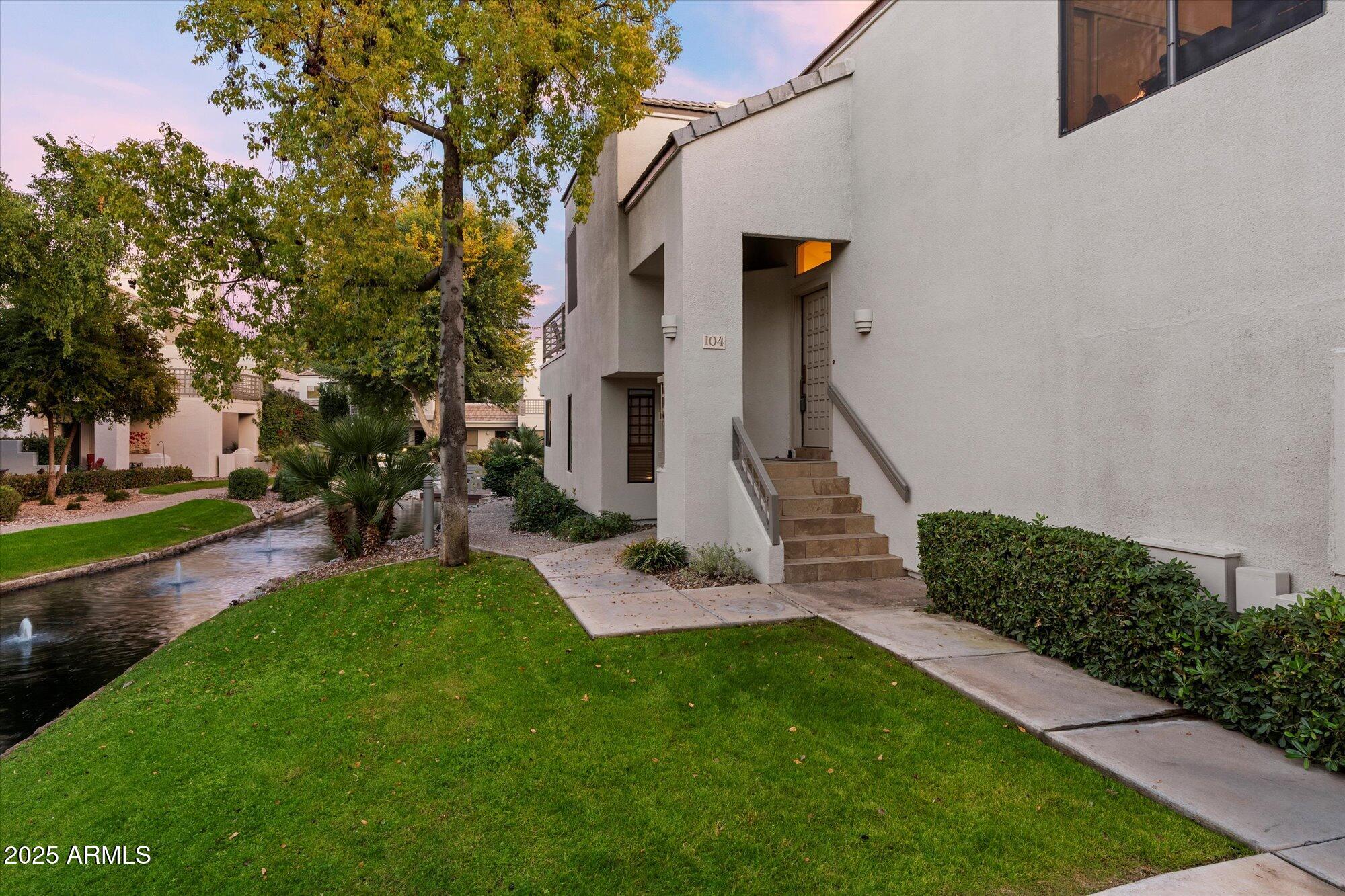 7272 East Gainey Ranch Road, Unit 104 Scottsdale, AZ 85258 - Photo 6 of 45 a view of a house with a yard