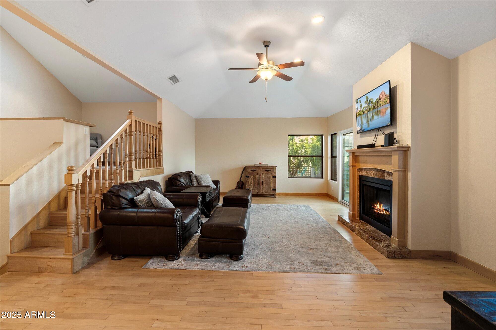 7272 East Gainey Ranch Road, Unit 104 Scottsdale, AZ 85258 - Photo 8 of 45 a living room with furniture a fireplace and a flat screen tv