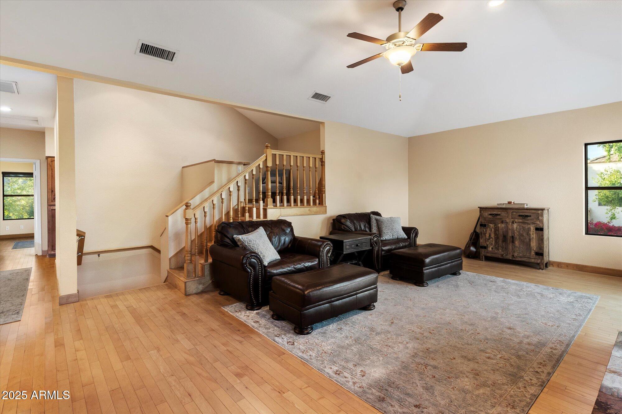 7272 East Gainey Ranch Road, Unit 104 Scottsdale, AZ 85258 - Photo 10 of 45 a living room with furniture and a wooden floor