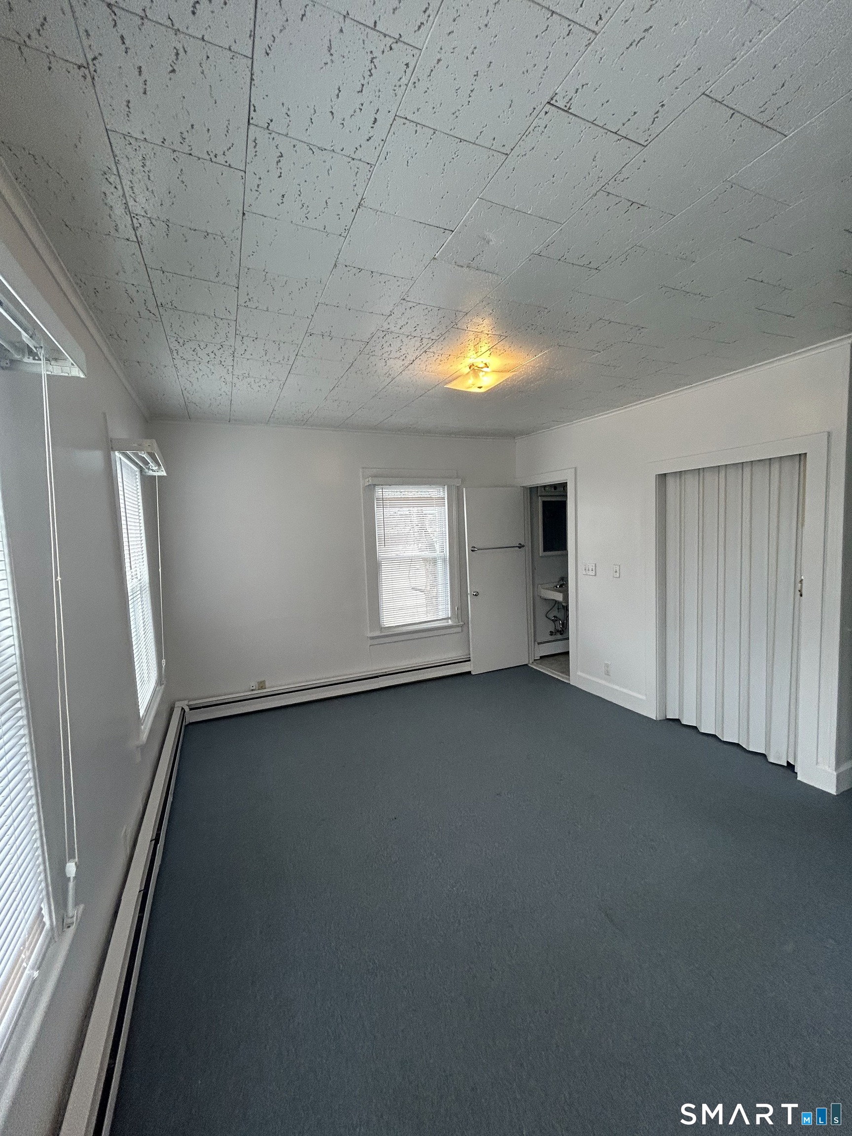 73 Peck Street, Unit 2 Norwich, CT 06360 - Photo 11 of 21 an empty room with a empty space and windows