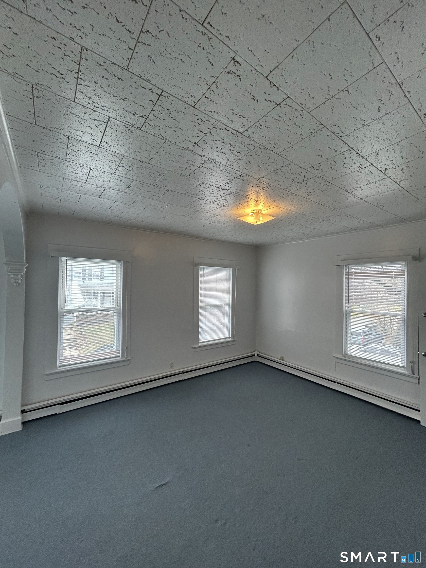 73 Peck Street, Unit 2 Norwich, CT 06360 - Photo 12 of 21 an empty room with a empty space and windows