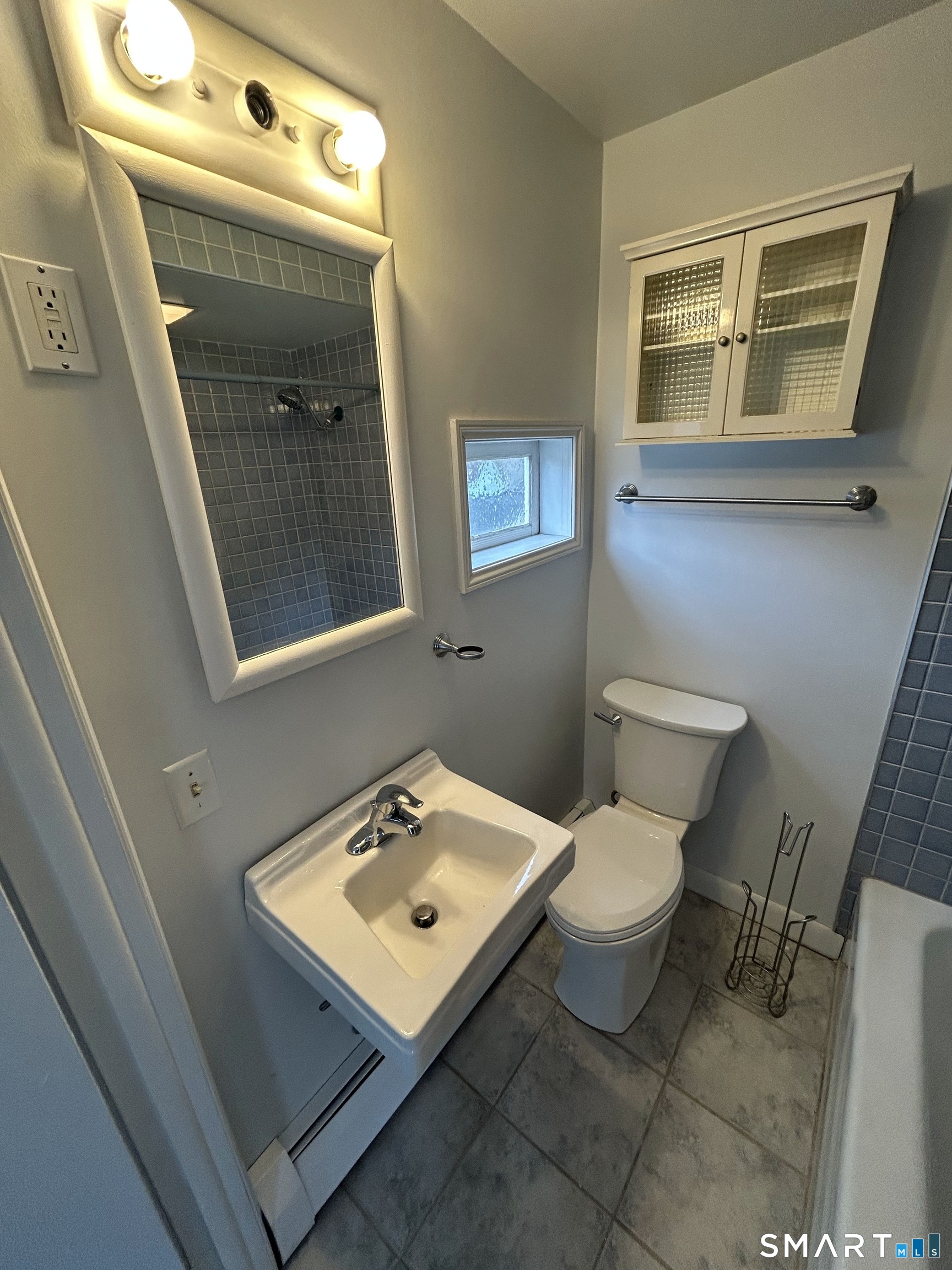 73 Peck Street, Unit 2 Norwich, CT 06360 - Photo 15 of 21 a bathroom with a toilet sink and mirror