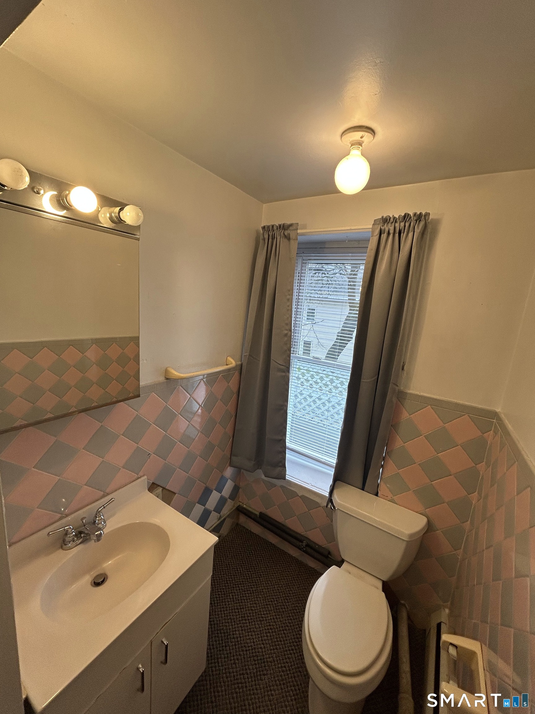 73 Peck Street, Unit 2 Norwich, CT 06360 - Photo 20 of 21 a bathroom with a sink mirror vanity and toilet