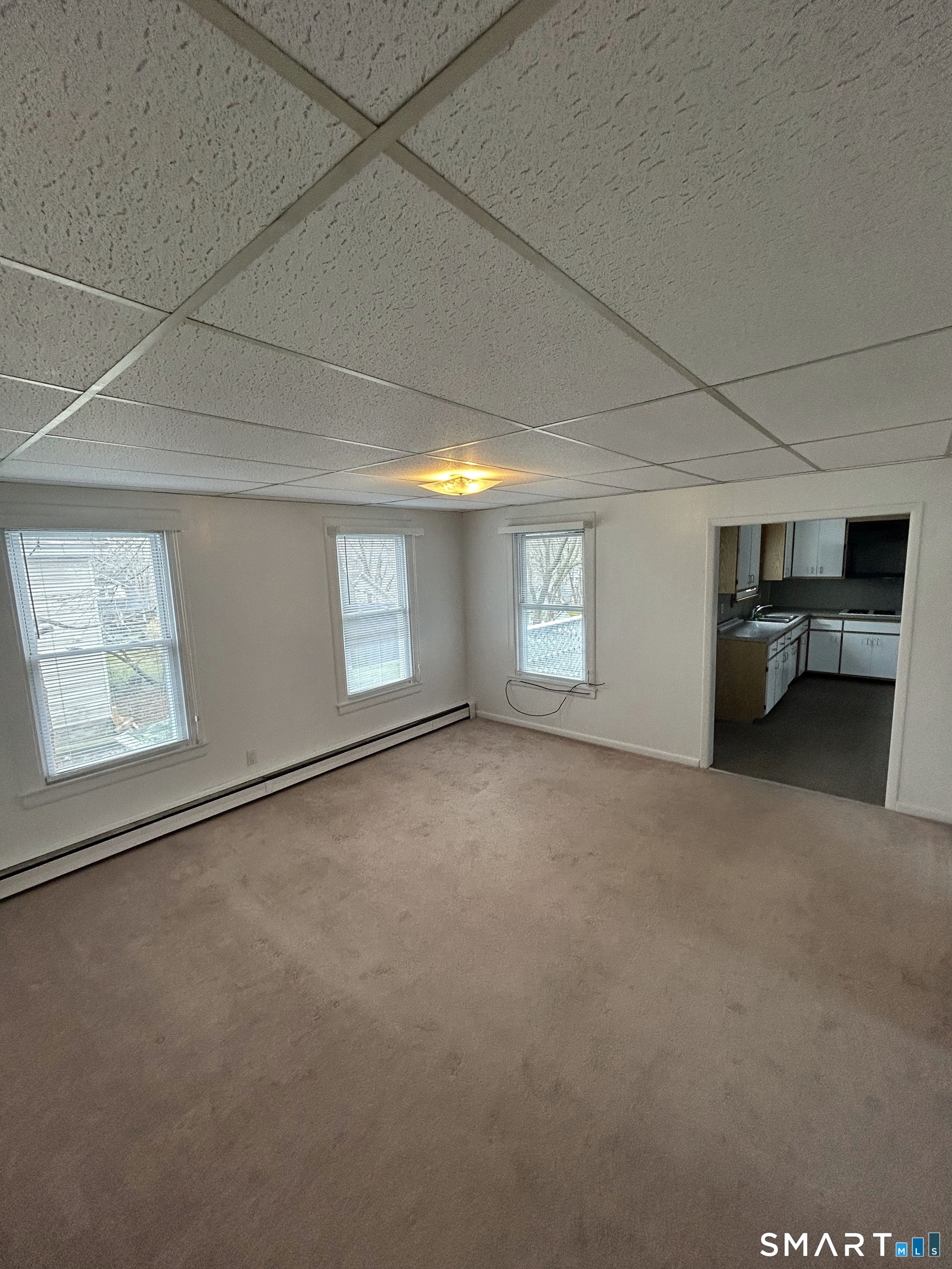 73 Peck Street, Unit 2 Norwich, CT 06360 - Photo 3 of 21 a view of empty room with windows