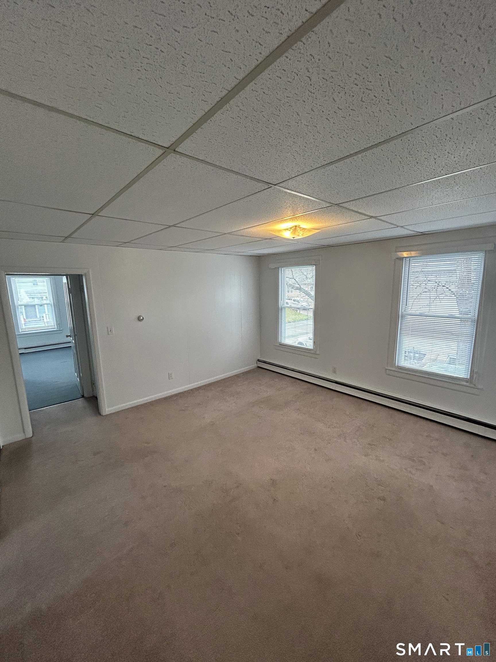 73 Peck Street, Unit 2 Norwich, CT 06360 - Photo 4 of 21 a view of an empty room with windows