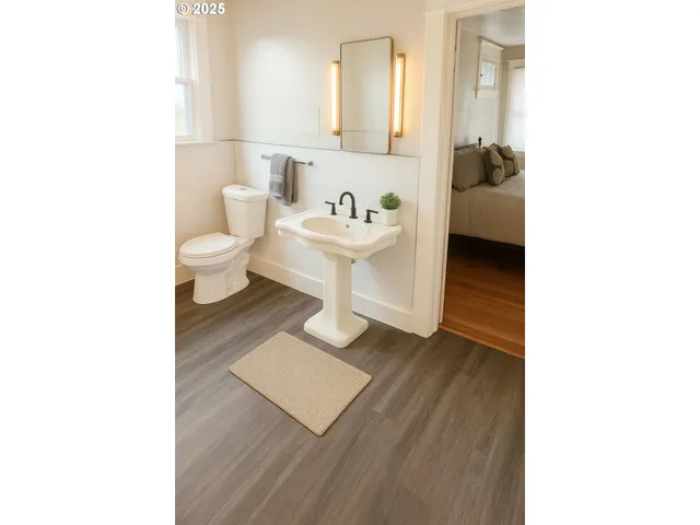 a bathroom with a toilet a sink and a mirror