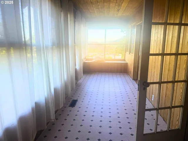 a roof deck with couches and wooden floor