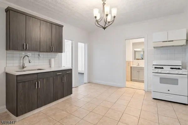a kitchen with a stove oven and a sink