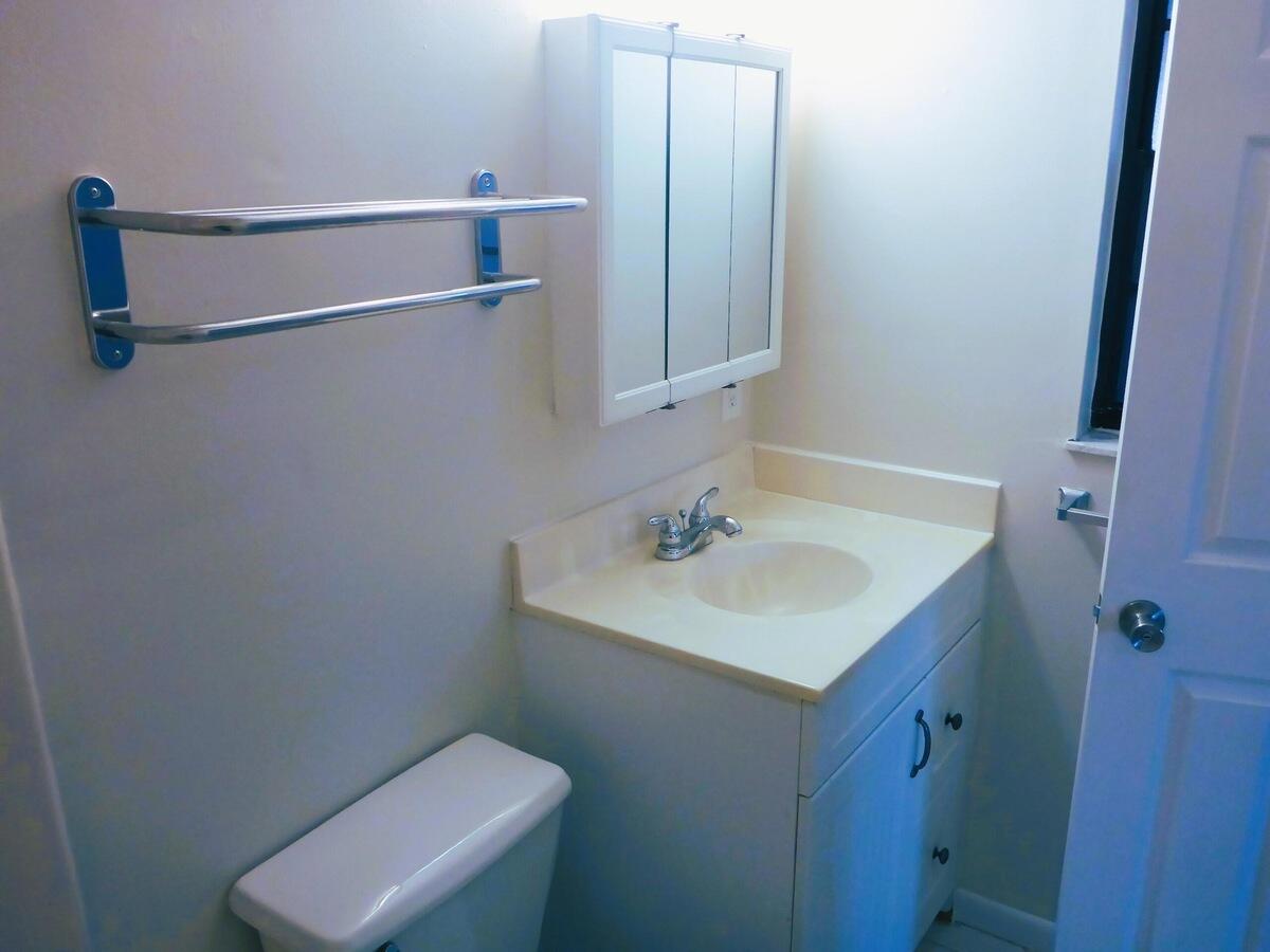 431 Jupiter Lakes Boulevard, Unit 2109A Jupiter, FL 33458 - Photo 21 of 23 a bathroom with a sink toilet and vanity