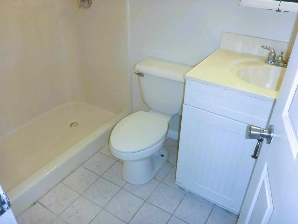 431 Jupiter Lakes Boulevard, Unit 2109A Jupiter, FL 33458 - Photo 22 of 23 a white toilet sitting next to a bath tub